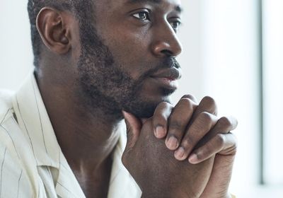 Close-up of a person's hands in a meditative pose.